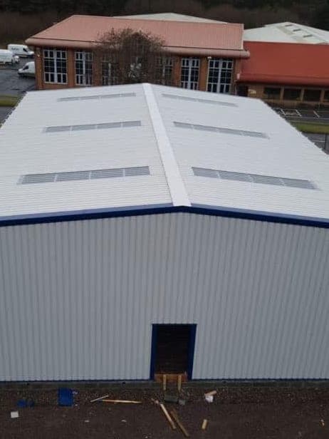 One of the Copart units from above: a single-skin roof and walls with a blue trim line