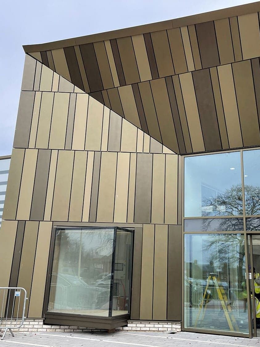 The entrance of the cancer care centre in Carlisle: bronze-toned aluminium fins over a glazed corner