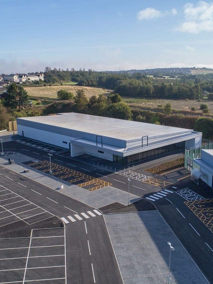 A Cowdenbeath Retail Park unit from above, with its car park and the town behind