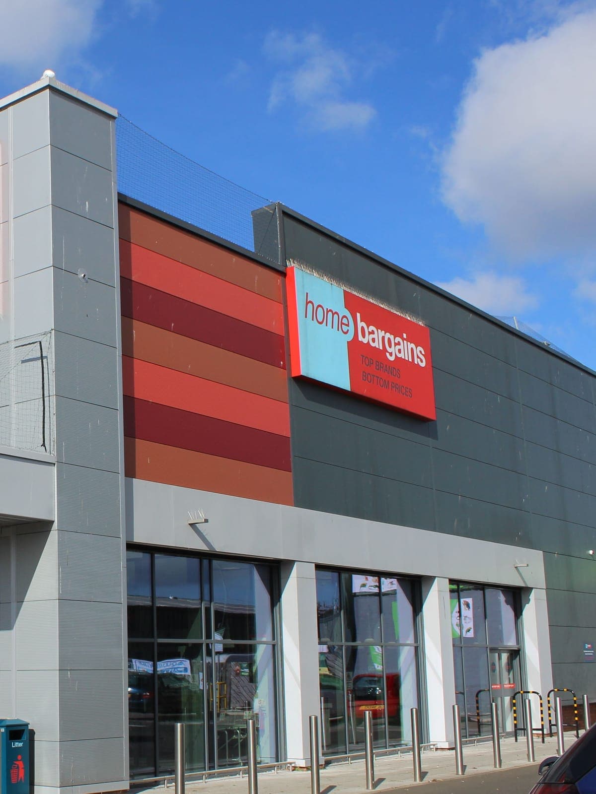 Red, orange and grey wall cladding down the side of the store