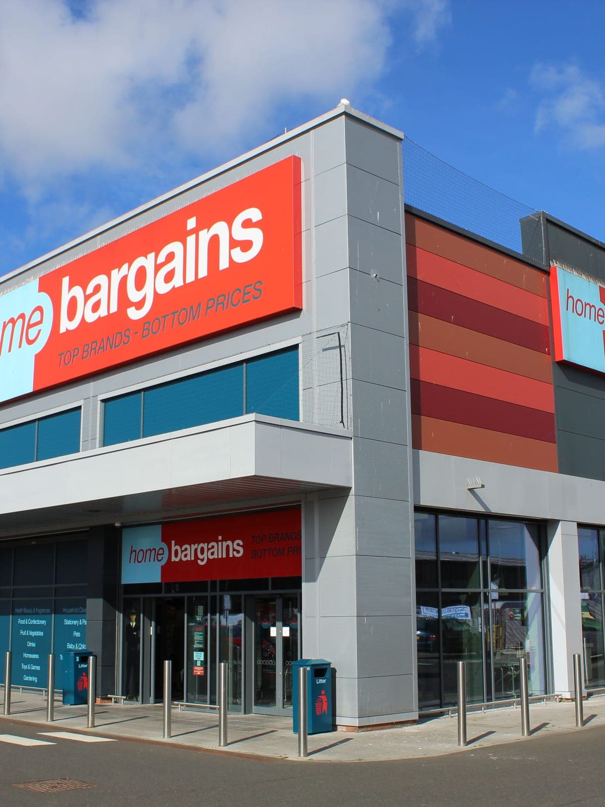 The corner of the Home Bargains store at Broxburn: red and grey cladding bands under the main sign