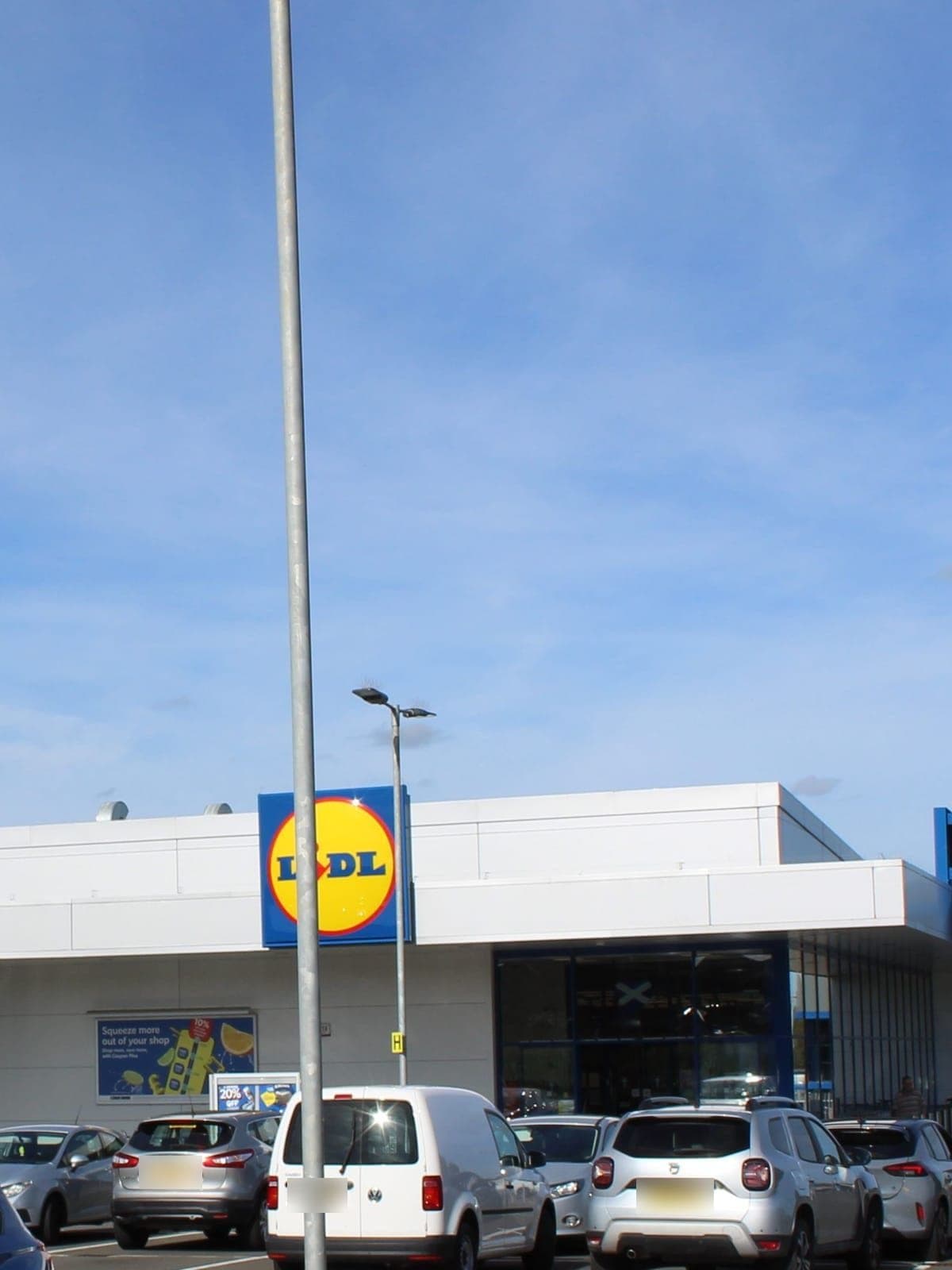 The store's white cladding and Lidl sign, seen across the car park