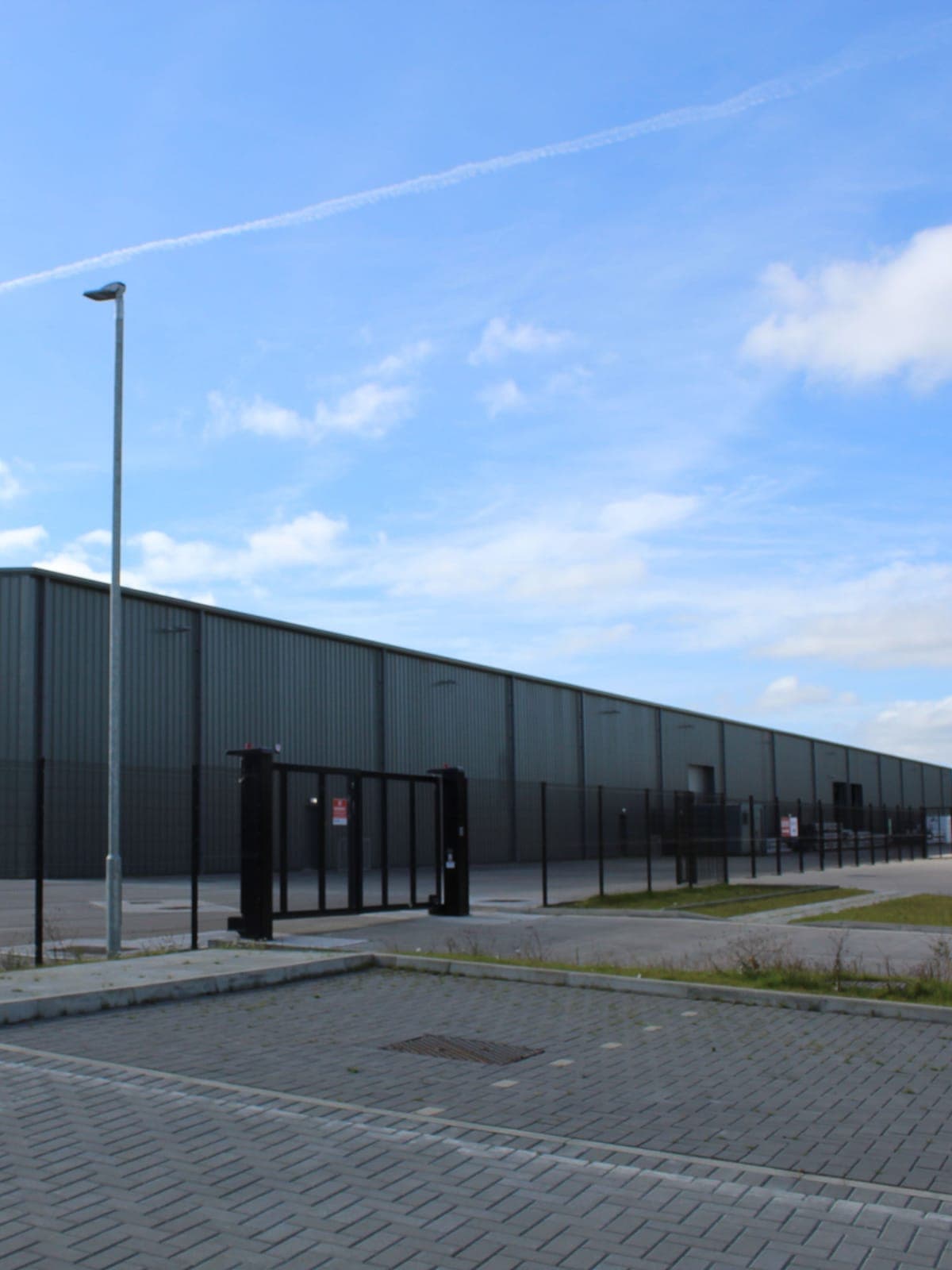 The long side of the warehouse and its roller doors