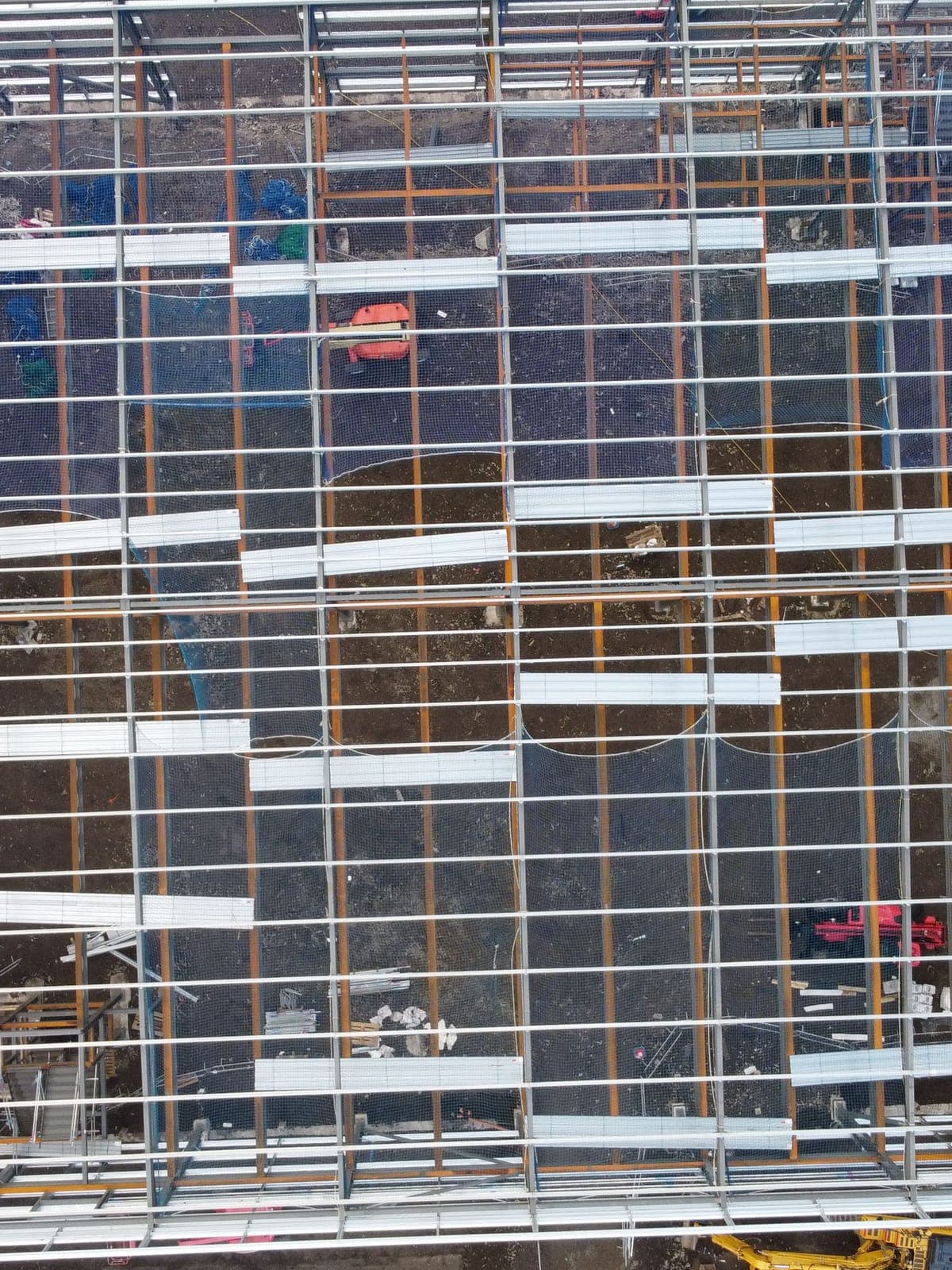 From above: the steel frame, with the first roof sheets going on